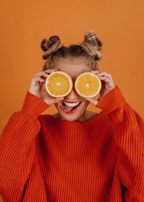 Sophie holding two slices of orange over her eyes